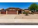Charming single-story home featuring low-maintenance landscaping and a spacious driveway leading to a two-car garage at 15256 N 62Nd Ave, Glendale, AZ 85306
