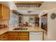 Kitchen peninsula with granite countertops and stainless steel sink, facing dining area at 15256 N 62Nd Ave, Glendale, AZ 85306