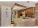 Spacious kitchen with granite countertop, oak cabinets, and access to the laundry room at 15256 N 62Nd Ave, Glendale, AZ 85306
