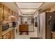 Bright kitchen with tiled floor, oak cabinets, stainless refrigerator, and backyard views at 15256 N 62Nd Ave, Glendale, AZ 85306