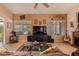 Living room with large windows, fireplace, ceiling fan and comfortable seating arrangement at 15256 N 62Nd Ave, Glendale, AZ 85306