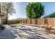 This backyard features a spacious patio, small lawn, and block fence providing a private outdoor space at 16242 W Maui Ln, Surprise, AZ 85379
