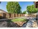 Spacious backyard with a brick fence, patio, and a small patch of grass, offering privacy and room to relax at 16242 W Maui Ln, Surprise, AZ 85379