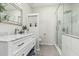 Elegant bathroom with a marble countertop vanity and glass-enclosed shower, offering a luxurious and relaxing space at 16242 W Maui Ln, Surprise, AZ 85379