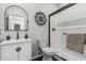 Elegant bathroom featuring a modern vanity and a glass-enclosed shower with black trim at 16242 W Maui Ln, Surprise, AZ 85379