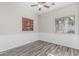 Empty bedroom with gray wood-look flooring, and a window with coverings at 16242 W Maui Ln, Surprise, AZ 85379