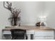 A clean and functional desk area with a spacious countertop and a vase of flowers at 16242 W Maui Ln, Surprise, AZ 85379