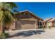 Beautiful single-story home with a large driveway and an attached two-car garage at 16242 W Maui Ln, Surprise, AZ 85379