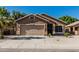Inviting single-story home with a well-kept lawn and an attached two-car garage at 16242 W Maui Ln, Surprise, AZ 85379