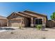 Lovely single-level home featuring desert landscaping, an oversized driveway, and an attached two-car garage at 16242 W Maui Ln, Surprise, AZ 85379