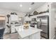Bright kitchen featuring white cabinetry, a large island, stainless steel appliances, and decorative accents at 16242 W Maui Ln, Surprise, AZ 85379