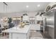 Modern kitchen featuring a large center island with white countertops and stainless steel appliances at 16242 W Maui Ln, Surprise, AZ 85379