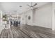 Spacious living room with hardwood floors that opens to a modern kitchen and dining area with stylish decor and fixtures at 16242 W Maui Ln, Surprise, AZ 85379