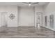 Large open-concept living room featuring stylish flooring, a ceiling fan, and easy access to other rooms at 16242 W Maui Ln, Surprise, AZ 85379