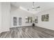 An airy living room boasting modern flooring, a contemporary ceiling fan, and sliding door access at 16242 W Maui Ln, Surprise, AZ 85379