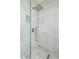 Modern shower featuring marble-look tile surround, a rainfall shower head, and handheld sprayer at 16242 W Maui Ln, Surprise, AZ 85379