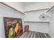 Bright, walk-in closet with wood laminate flooring, shelving, and ample storage space at 16242 W Maui Ln, Surprise, AZ 85379