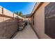 View of covered backyard patio with workbench, stool, and convenient outdoor space at 16365 N 138Th Ave, Surprise, AZ 85374