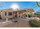 Backyard with covered patio, gravel landscaping, and barbecue area, perfect for enjoying the outdoors at 16365 N 138Th Ave, Surprise, AZ 85374