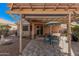 Inviting backyard patio with pergola, comfortable seating, and lush landscaping for outdoor enjoyment at 16365 N 138Th Ave, Surprise, AZ 85374