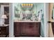 Clean bathroom features dark wooden cabinets and double mirror at 16365 N 138Th Ave, Surprise, AZ 85374