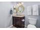 Cozy powder room with decorative mirror, tiled floors, and marble countertops at 16365 N 138Th Ave, Surprise, AZ 85374