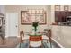 Charming dining area featuring a glass table, wood chairs and stylish decor at 16365 N 138Th Ave, Surprise, AZ 85374