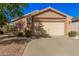 Charming single-story home with a two-car garage, desert landscaping and tile roof at 16365 N 138Th Ave, Surprise, AZ 85374