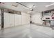 Clean, organized garage with ample storage, cabinets, and workspace, suitable for various projects at 16365 N 138Th Ave, Surprise, AZ 85374