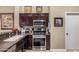 Well-equipped kitchen with stainless steel appliances and dark wood cabinetry at 16365 N 138Th Ave, Surprise, AZ 85374
