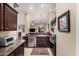 Beautiful kitchen featuring stainless steel appliances and an open floor plan to living area at 16365 N 138Th Ave, Surprise, AZ 85374
