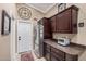 Lovely kitchen featuring stainless steel refrigerator, dark cabinets, and ample counter space at 16365 N 138Th Ave, Surprise, AZ 85374