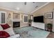 Bright living room with a fireplace, wood floors, and a ceiling fan at 16365 N 138Th Ave, Surprise, AZ 85374