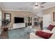Open-concept living room featuring wood floors, a ceiling fan and lots of natural light at 16365 N 138Th Ave, Surprise, AZ 85374