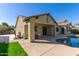 Backyard with a covered patio, built-in BBQ, and a private pool with an extended deck at 16758 W Apache St, Goodyear, AZ 85338