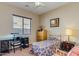 Cozy bedroom with a large window and a comfortable bed and furnishings at 16758 W Apache St, Goodyear, AZ 85338