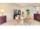 Open dining room with tile flooring, glass table and four upholstered chairs at 16758 W Apache St, Goodyear, AZ 85338