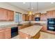 Spacious kitchen featuring granite countertops, an island, and modern appliances at 16758 W Apache St, Goodyear, AZ 85338