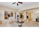 Open concept living room with wood flooring leading into dining and kitchen area at 16758 W Apache St, Goodyear, AZ 85338
