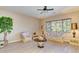 Bright living room with neutral walls, light wood floors and ample seating arrangement at 16758 W Apache St, Goodyear, AZ 85338