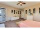 Spacious main bedroom featuring neutral paint, carpet, ceiling fan and access to outdoor patio at 16758 W Apache St, Goodyear, AZ 85338