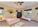 Comfortable main bedroom featuring natural light, ceiling fan and unique decor elements at 16758 W Apache St, Goodyear, AZ 85338