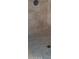 Tiled shower stall with tile flooring and bronze shower fixture at 16758 W Apache St, Goodyear, AZ 85338