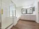 Bathroom features a tile-and-glass shower, soaking tub, double vanity, and tiled floor at 1679 E Oakland St, Gilbert, AZ 85295