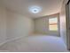 Carpeted bedroom with a double-door closet, light and a large window at 1679 E Oakland St, Gilbert, AZ 85295