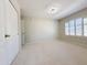 Neutral bedroom with light carpeting, plantation shutters, and ceiling fan at 1679 E Oakland St, Gilbert, AZ 85295