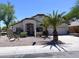 Charming single-story home with desert landscaping, palm trees, and a two-car garage at 1679 E Oakland St, Gilbert, AZ 85295