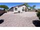 View of the home's backyard, featuring desert landscaping and covered patio at 1679 E Oakland St, Gilbert, AZ 85295