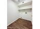 Laundry room features wood-look floors, storage shelf and washer and dryer hookups at 1679 E Oakland St, Gilbert, AZ 85295