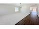 Bright and airy living room featuring dual flooring and modern lighting at 1679 E Oakland St, Gilbert, AZ 85295